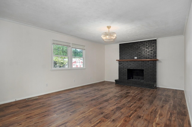 2411 S Rogers Ave, Springfield, MO 65804 - unfurnished living room featuring ornamental molding, wood finished floors, a chandelier, a fireplace, and a textured ceiling