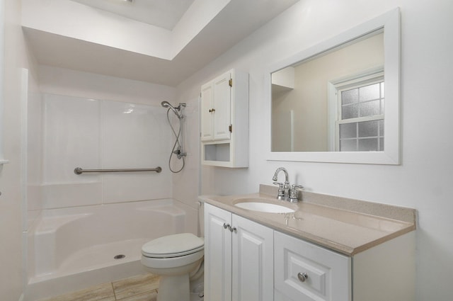 2411 S Rogers Ave, Springfield, MO 65804 - full bathroom with vanity, toilet, a shower, and wood finished floors