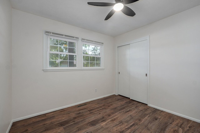 2411 S Rogers Ave, Springfield, MO 65804 - unfurnished bedroom with dark wood-type flooring, baseboards, a closet, and a ceiling fan
