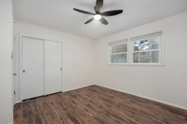 2411 S Rogers Ave, Springfield, MO 65804 - unfurnished bedroom with wood finished floors, baseboards, a closet, and a ceiling fan