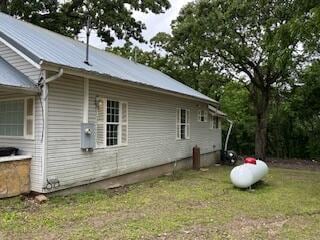 21461 Needles Eye Rd, Shell Knob, MO 65747 - view of side of home featuring a lawn and metal roof