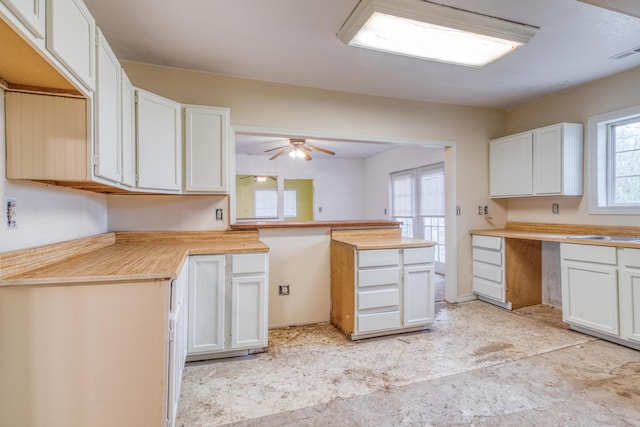 21461 Needles Eye Rd, Shell Knob, MO 65747 - kitchen featuring white cabinets, a peninsula, ceiling fan, light countertops, and a sink