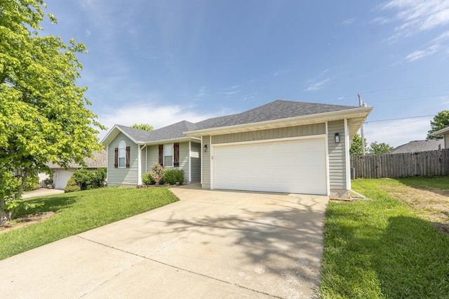 317 Cinnamon Ct, Sparta, MO 65753 - ranch-style home featuring an attached garage, driveway, and a shingled roof