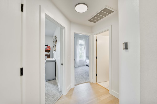 317 Cinnamon Ct, Sparta, MO 65753 - hall featuring light wood-type flooring, washer / dryer, and baseboards
