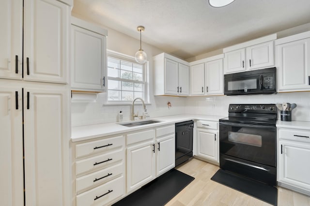317 Cinnamon Ct, Sparta, MO 65753 - kitchen with black appliances, a sink, light wood-type flooring, light countertops, and decorative backsplash