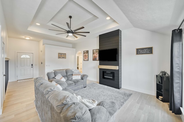 317 Cinnamon Ct, Sparta, MO 65753 - living room with a tray ceiling, ceiling fan, arched walkways, light wood-style floors, and recessed lighting