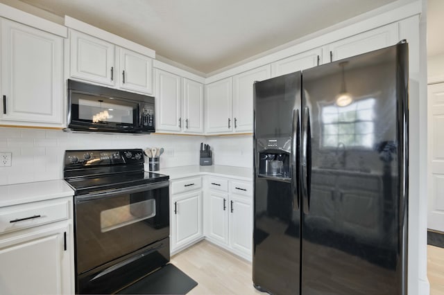 317 Cinnamon Ct, Sparta, MO 65753 - kitchen featuring black appliances, light countertops, white cabinets, decorative backsplash, and light wood finished floors