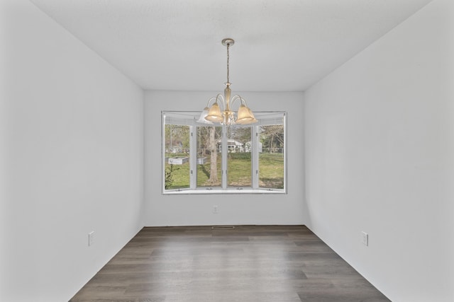 824 Highland Dr, Aurora, MO 65605 - empty room featuring a chandelier and wood finished floors