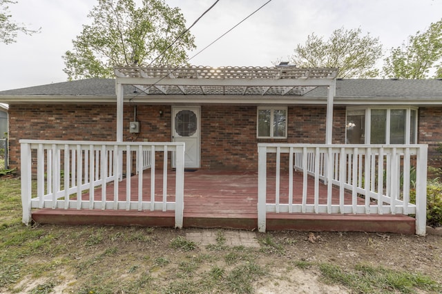 824 Highland Dr, Aurora, MO 65605 - view of front of house with brick siding, a wooden deck, and a chimney