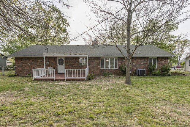 824 Highland Dr, Aurora, MO 65605 - rear view of property featuring a wooden deck, central air condition unit, a chimney, brick siding, and a shingled roof