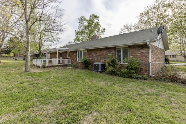 824 Highland Dr, Aurora, MO 65605 - rear view of property with brick siding, central air condition unit, a chimney, a wooden deck, and roof with shingles