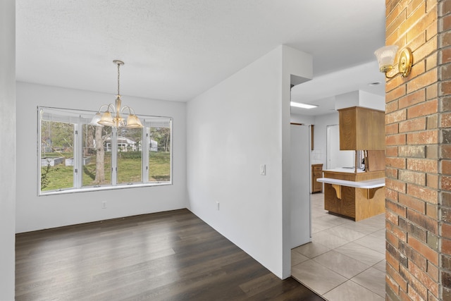 824 Highland Dr, Aurora, MO 65605 - unfurnished dining area with wood finished floors and a chandelier