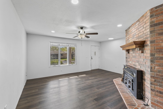 824 Highland Dr, Aurora, MO 65605 - unfurnished living room featuring dark wood finished floors, ceiling fan, a wood stove, and recessed lighting