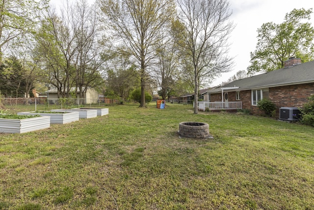 824 Highland Dr, Aurora, MO 65605 - view of yard featuring a garden, a fire pit, and central air condition unit