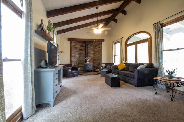 1831 E Woodbine St, Springfield, MO 65803 - living room featuring a wood stove, light carpet, beamed ceiling, ceiling fan, and high vaulted ceiling
