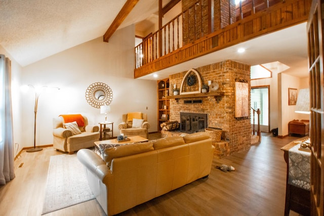 1831 E Woodbine St, Springfield, MO 65803 - living room with wood finished floors, a fireplace, baseboards, and high vaulted ceiling