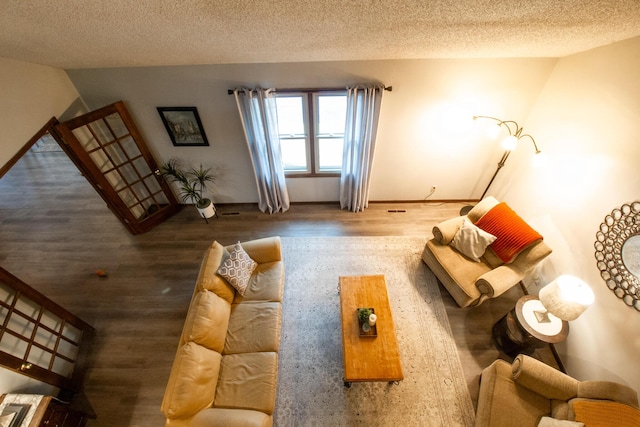 1831 E Woodbine St, Springfield, MO 65803 - living room featuring wood finished floors, a textured ceiling, and baseboards