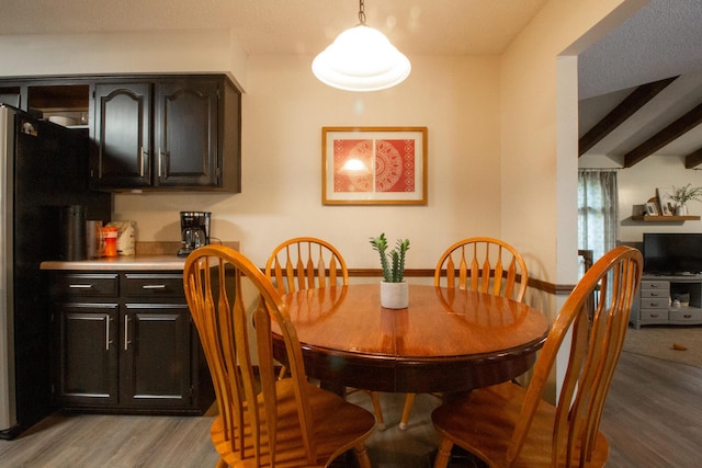 1831 E Woodbine St, Springfield, MO 65803 - dining room featuring light wood-style flooring and beam ceiling