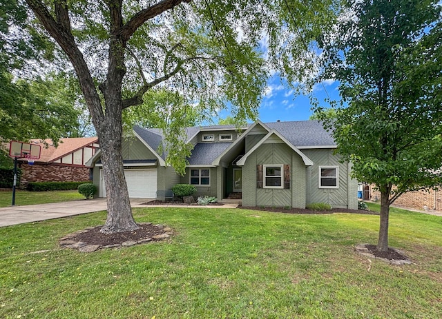 1831 E Woodbine St, Springfield, MO 65803 - view of front of house featuring a garage, roof with shingles, driveway, and a front lawn