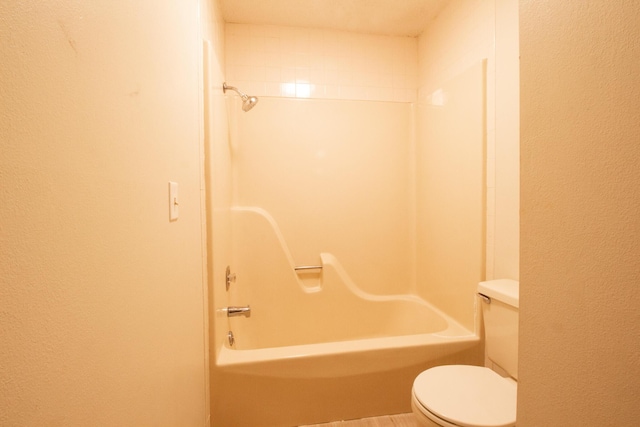 1831 E Woodbine St, Springfield, MO 65803 - full bathroom with toilet, a textured wall, and bathtub / shower combination