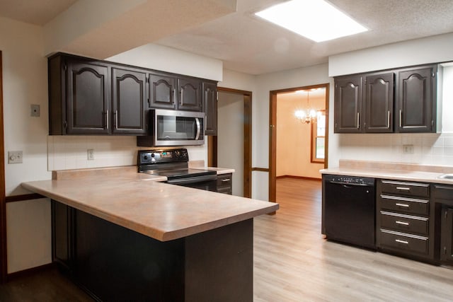 1831 E Woodbine St, Springfield, MO 65803 - kitchen featuring black appliances, light countertops, and decorative backsplash