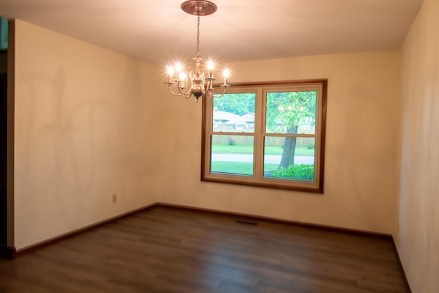 1831 E Woodbine St, Springfield, MO 65803 - empty room with dark wood-type flooring, a chandelier, and baseboards