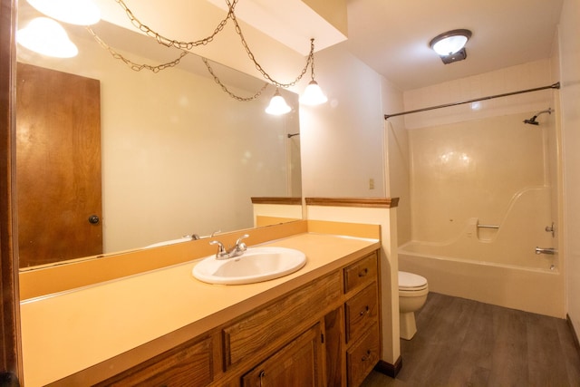 1831 E Woodbine St, Springfield, MO 65803 - bathroom with toilet, vanity, bathtub / shower combination, and wood finished floors