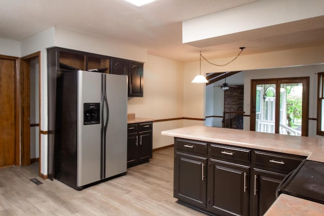 1831 E Woodbine St, Springfield, MO 65803 - kitchen with stainless steel fridge with ice dispenser, a ceiling fan, light wood-type flooring, black electric range oven, and a brick fireplace