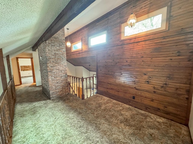 1831 E Woodbine St, Springfield, MO 65803 - bonus room featuring vaulted ceiling, carpet flooring, a textured ceiling, and wooden walls