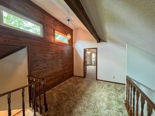 1831 E Woodbine St, Springfield, MO 65803 - bonus room featuring wood walls, a textured ceiling, and carpet