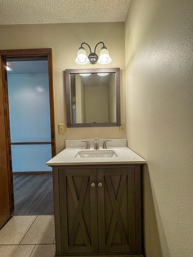 1831 E Woodbine St, Springfield, MO 65803 - bathroom with vanity, tile patterned flooring, and a textured ceiling