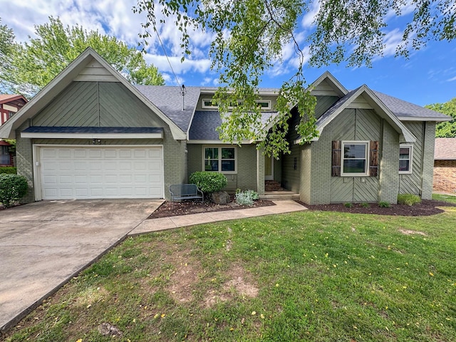 1831 E Woodbine St, Springfield, MO 65803 - view of front facade featuring brick siding, an attached garage, concrete driveway, and a front yard
