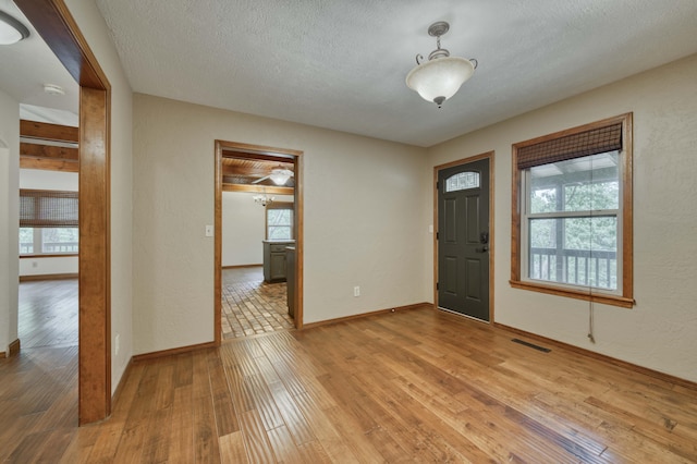 224 Loveland Dr, Rogersville, MO 65742 - foyer with light wood-style flooring, a textured ceiling, and baseboards