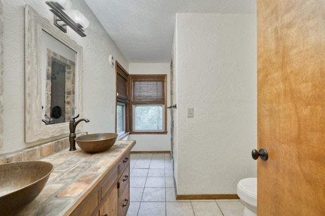 224 Loveland Dr, Rogersville, MO 65742 - bathroom with a textured wall, double vanity, toilet, tile patterned flooring, and a textured ceiling