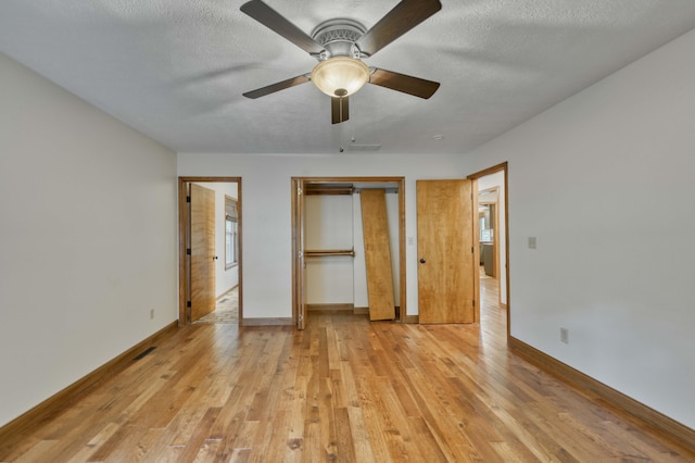 224 Loveland Dr, Rogersville, MO 65742 - unfurnished bedroom featuring light wood-type flooring, a closet, baseboards, a textured ceiling, and ceiling fan