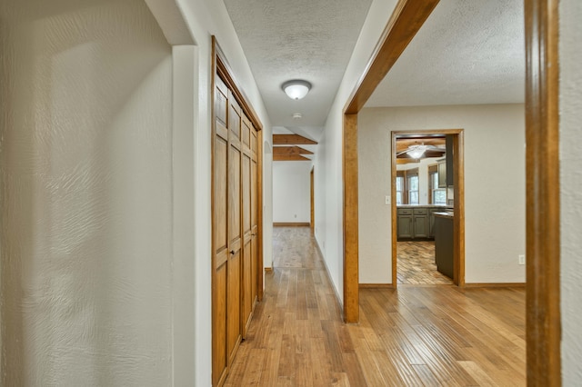 224 Loveland Dr, Rogersville, MO 65742 - hallway with a textured ceiling, light wood-style floors, and baseboards