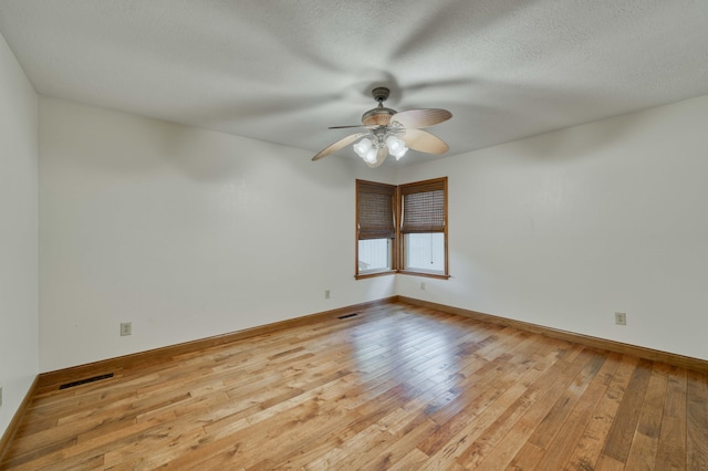 224 Loveland Dr, Rogersville, MO 65742 - spare room with light wood-style floors, ceiling fan, baseboards, and a textured ceiling