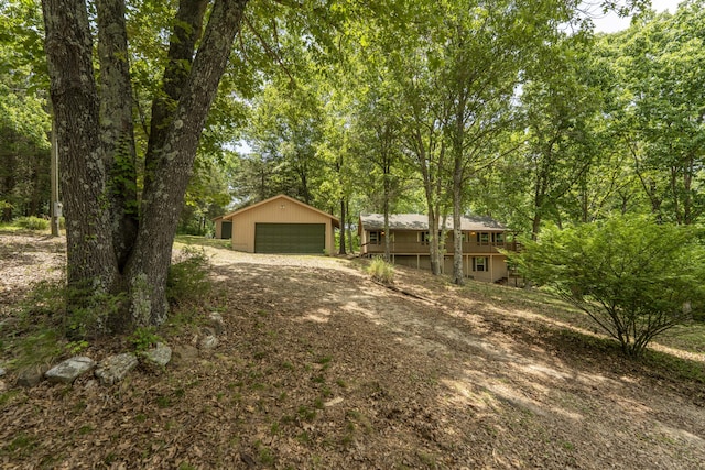 224 Loveland Dr, Rogersville, MO 65742 - view of front facade featuring an outbuilding, a garage, and a wooden deck
