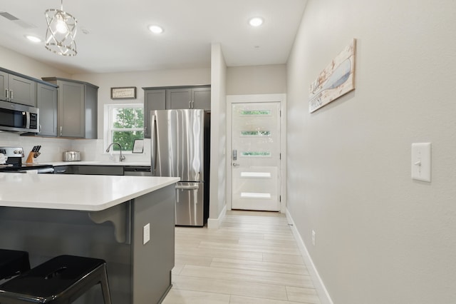 232 Chateau Mountain Hilltop Way, Branson, MO 65616 - kitchen with stainless steel appliances, light countertops, a kitchen breakfast bar, backsplash, and recessed lighting