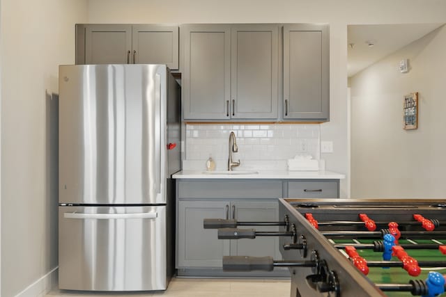 232 Chateau Mountain Hilltop Way, Branson, MO 65616 - kitchen featuring freestanding refrigerator, gray cabinetry, a sink, decorative backsplash, and light countertops