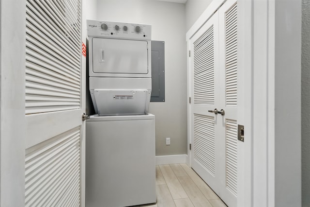 232 Chateau Mountain Hilltop Way, Branson, MO 65616 - washroom with stacked washing machine and dryer, baseboards, electric panel, and light wood finished floors