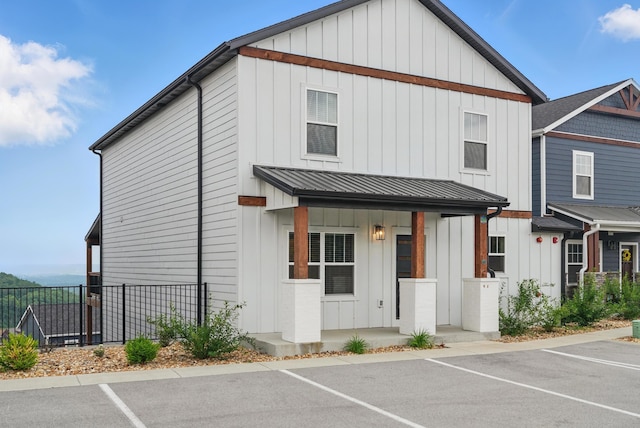 232 Chateau Mountain Hilltop Way, Branson, MO 65616 - townhome / multi-family property featuring board and batten siding, uncovered parking, metal roof, and covered porch