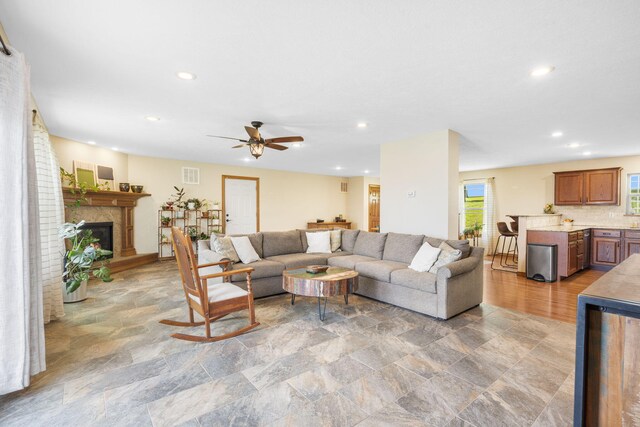6755 W Farm Rd Unit 194, Republic, MO 65738 - living area featuring light stone finish flooring, ceiling fan, recessed lighting, and a glass covered fireplace