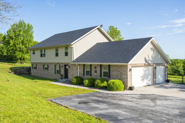 6755 W Farm Rd Unit 194, Republic, MO 65738 - colonial-style house with a garage, concrete driveway, a shingled roof, brick siding, and a front yard
