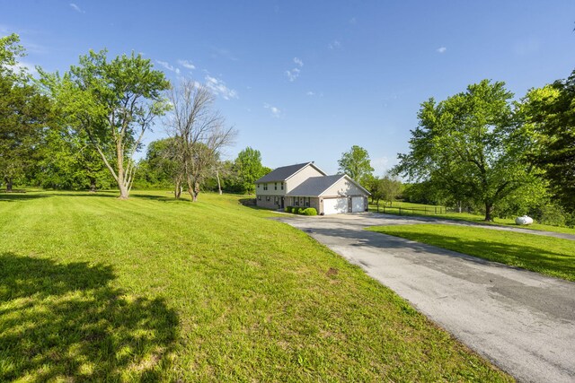 6755 W Farm Rd Unit 194, Republic, MO 65738 - view of front of house featuring driveway, a front yard, and an attached garage