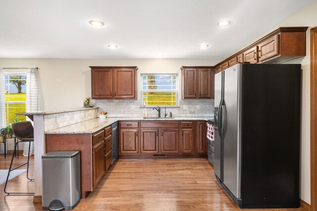 6755 W Farm Rd Unit 194, Republic, MO 65738 - kitchen with fridge with ice dispenser, a peninsula, stainless steel dishwasher, a breakfast bar, and a sink