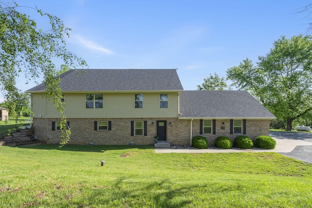6755 W Farm Rd Unit 194, Republic, MO 65738 - colonial home featuring a front lawn, roof with shingles, and brick siding