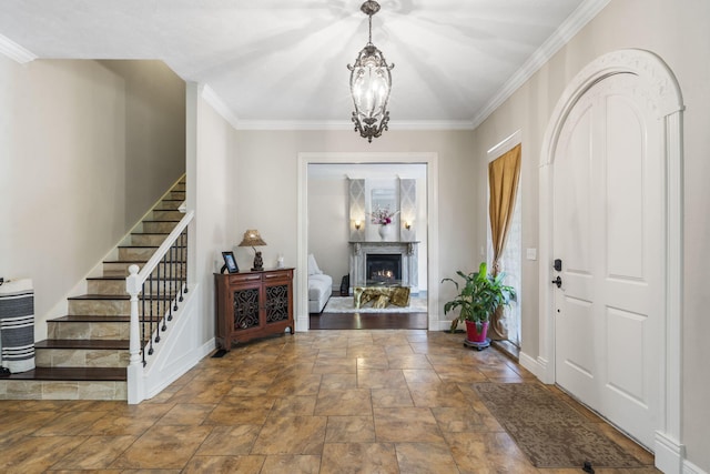 200 Barnes Ln, Branson, MO 65616 - foyer with stairway, ornamental molding, stone finish floors, a chandelier, and baseboards