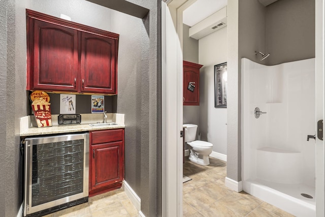 200 Barnes Ln, Branson, MO 65616 - indoor bar with beverage cooler, a textured wall, and baseboards