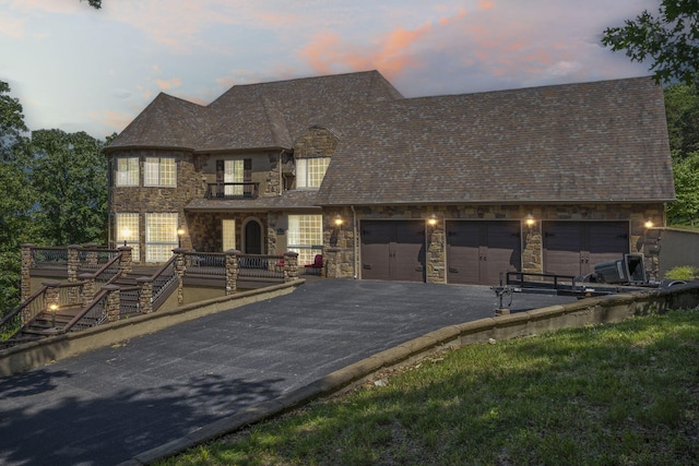 200 Barnes Ln, Branson, MO 65616 - view of front facade featuring stone siding, asphalt driveway, a garage, and stairs